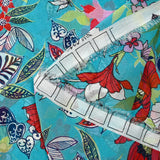 Muslin printed with exotic red and white flowers on a turquoise background