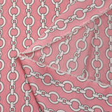 Lightweight polyester satin with white chain link print on pink background