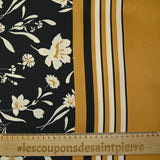 Satin polyester twill printed with ecru flowers and ocher border, black background