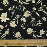 Satin polyester twill printed with ecru flowers and ocher border, black background