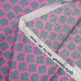 Coated poplin with green plant print, pink background