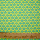 Coated poplin with turquoise vegetable print on lemon background