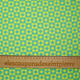 Coated poplin printed with fields of flowers, green lemon background