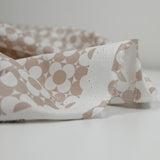 Coated poplin printed with fields of flowers, beige, white background