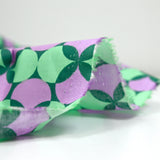 Coated poplin printed with polka dots & purple clover green background