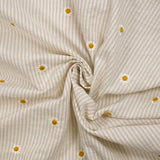 Coton tissé teint brodé marguerite fond rayé blanc et beige
