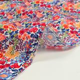 Matilde de algodón Matilde Naranja y flores azules por metro