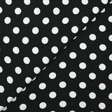Viscose twill printed with polka dots on a black background