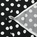 Viscose twill printed with polka dots on a black background
