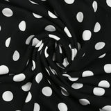 Viscose twill printed with polka dots on a black background