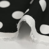 Viscose twill printed with polka dots on a black background