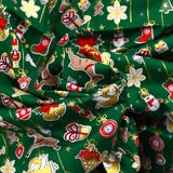 Popeline de coton imprimée esprit de Noël doré fond vert