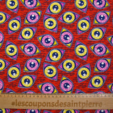 Coton imprimé ethnique Kampen rose et jaune fond rouge