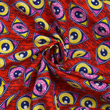 Coton imprimé ethnique Kampen rose et jaune fond rouge
