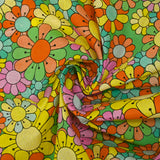 Algodón estampado flower power rosa fondo verde
