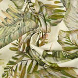 Natural printed viscose in green leaves on an ecru background