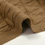Jersey matelassé triangle fond beige foncé