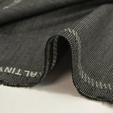 Light gray fantasy wool blend suit fabric with black background