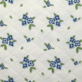 Jersey de coton matelassé imprimé fleurettes bleu fond blanc