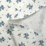 Jersey de coton matelassé imprimé fleurettes bleu fond blanc