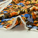 Mousseline crinkle satinée tableau de fleurs jaunes et bleues fond marron