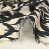 Black ikat printed polyester satin with ecru background