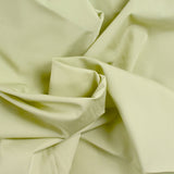 Popeline of a tilleulous green cotton