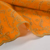 Broderie anglaise festonnée beige Éléonore fond orange