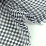 Polyester muslin with small navy and white tiles