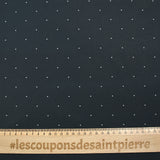 Cotton printed with mini polka dots on a midnight blue background