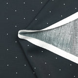 Cotton printed with mini polka dots on a midnight blue background