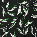 Maille de viscose satinée imprimée brin de muguet fond noir