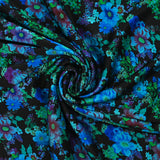 Maille de viscose satinée imprimée champs de fleurs bleu fond noir