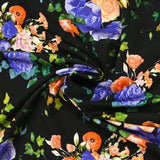 Maille de viscose satinée imprimée fleurs de nuit pêche et bleu fond noir