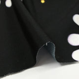 Maille de viscose satinée imprimée éclipse orange fond noir