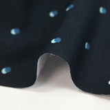 Cotton jersey printed with polka dots on a midnight blue background