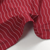 Cotton jersey printed wavy stripe burgundy background