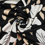 Raso de poliéster estampado fragmento beige y flor crudo fondo negro