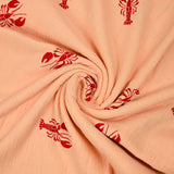 Double gauze printed with red lobster and apricot background