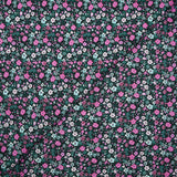 Cotton voile digitally printed meadow of small pink and water green flowers on a black background