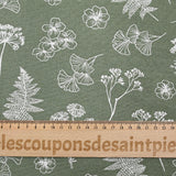 Cotton poplin printed with white botanical herbarium on a sage green background