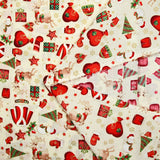 Cotton poplin printed with reindeer, snowmen and gifts on an ecru background