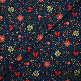 Cotton poplin printed with poinsettias and red bows on a navy blue background