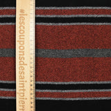 100% felted wool rust and gray stripe black background
