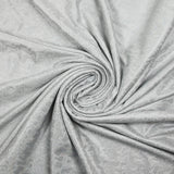 Jersey printed with holographic silver polka dots on white background