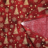 Popeline de coton imprimée sapins dorés fond marbré rouge