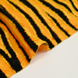 Maille velours et lurex tigre noir fond jaune orangé