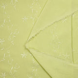 Voile de polyester brodé fleurs et feuillages vert anis
