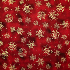 Popeline de coton imprimée flocons de neige dorés fond marbré rouge