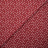 Popeline de coton imprimée rameaux et étoiles blanches fond rouge